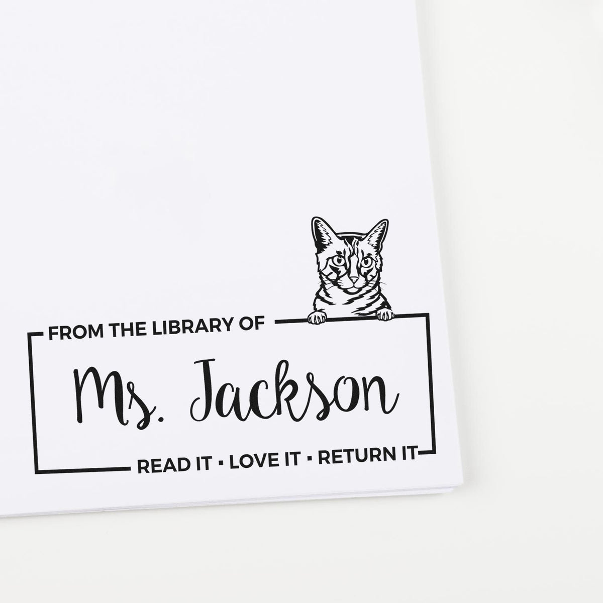 Custom cat book stamp for Ms. Jackson, with From the Library of and Read it, Love it, Return it text.