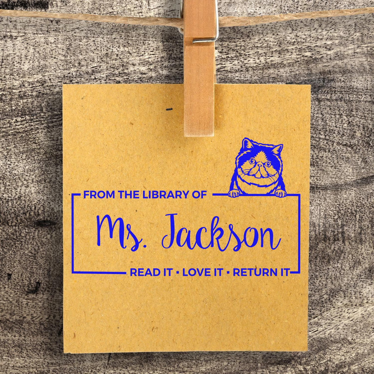 Personalized cat library rubber stamp for Ms. Jackson with From the library of and Read it, love it, return it message.
