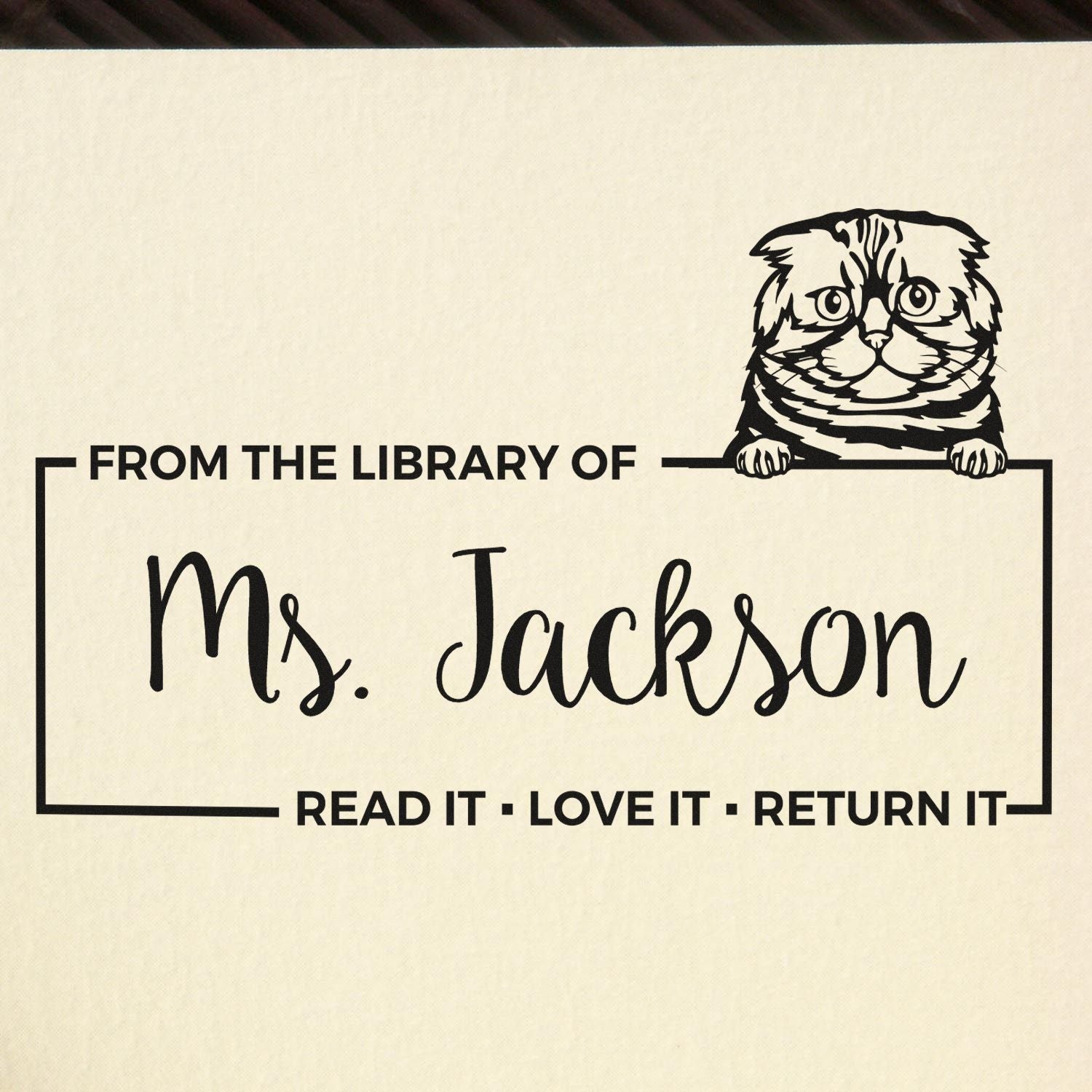 Custom library rubber stamp with cat design reading From the Library of Ms. Jackson Read It, Love It, Return It.