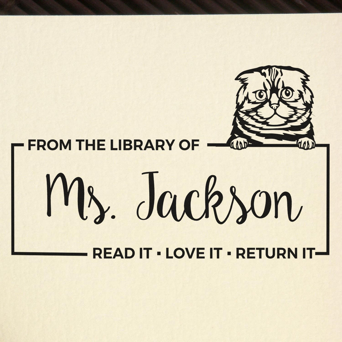 Custom library rubber stamp for Ms. Jackson with cat design and Read it, love it, return it bookplate message.