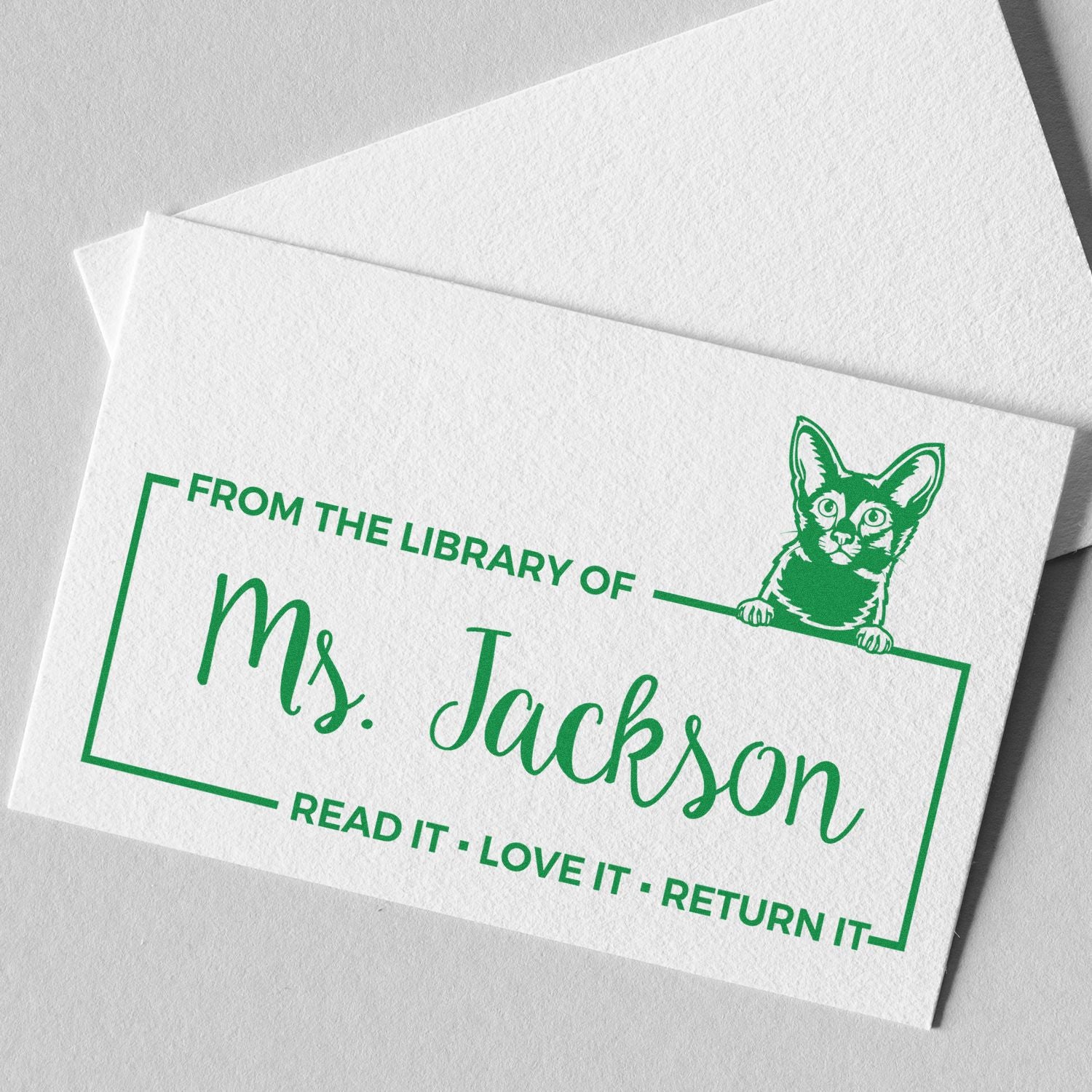 Custom library rubber stamp with cat design for Mrs. Jackson, reading Read it, love it, return it.