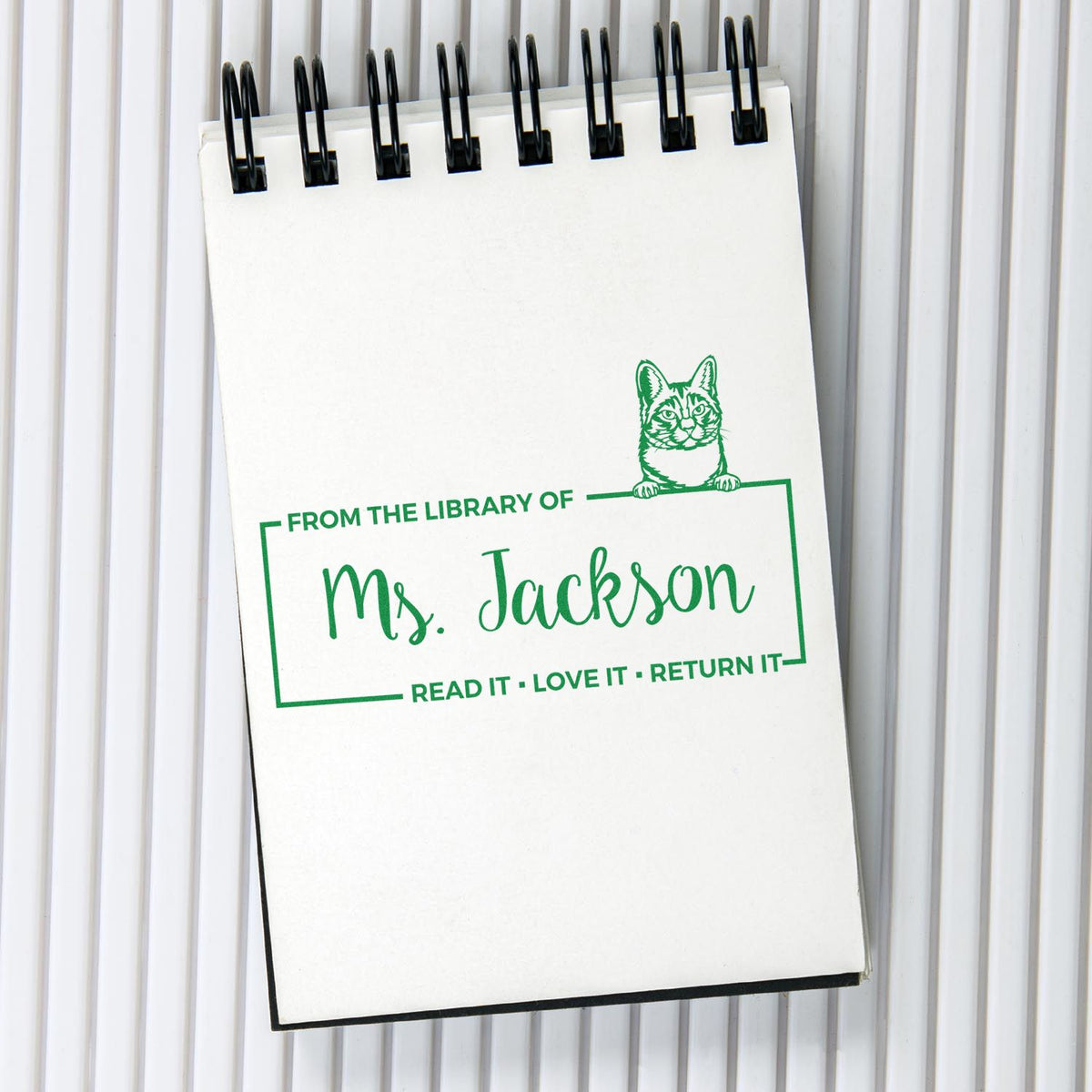 Personalized library rubber stamp with cat design for Ms. Jackson, reading Read it, Love it, Return it.