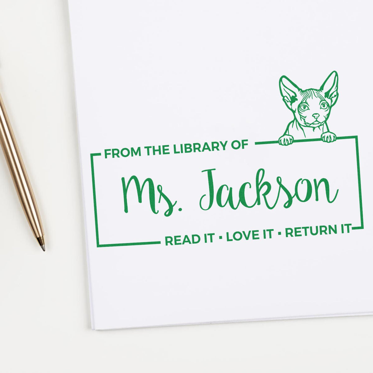 Personalized cat library rubber stamp reading "From the Library of Ms. Jackson" with "Read it, Love it, Return it" bookplate.