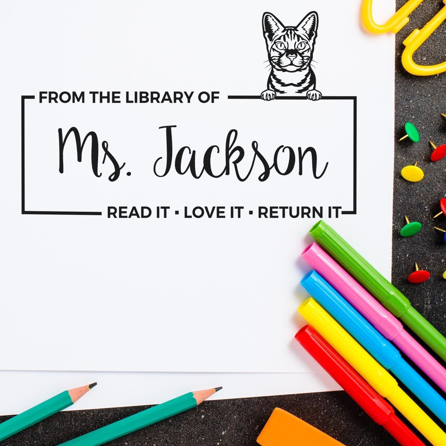 Custom classroom library rubber stamp with cat design, Ms. Jackson name, and Read it, love it, return it reminder.