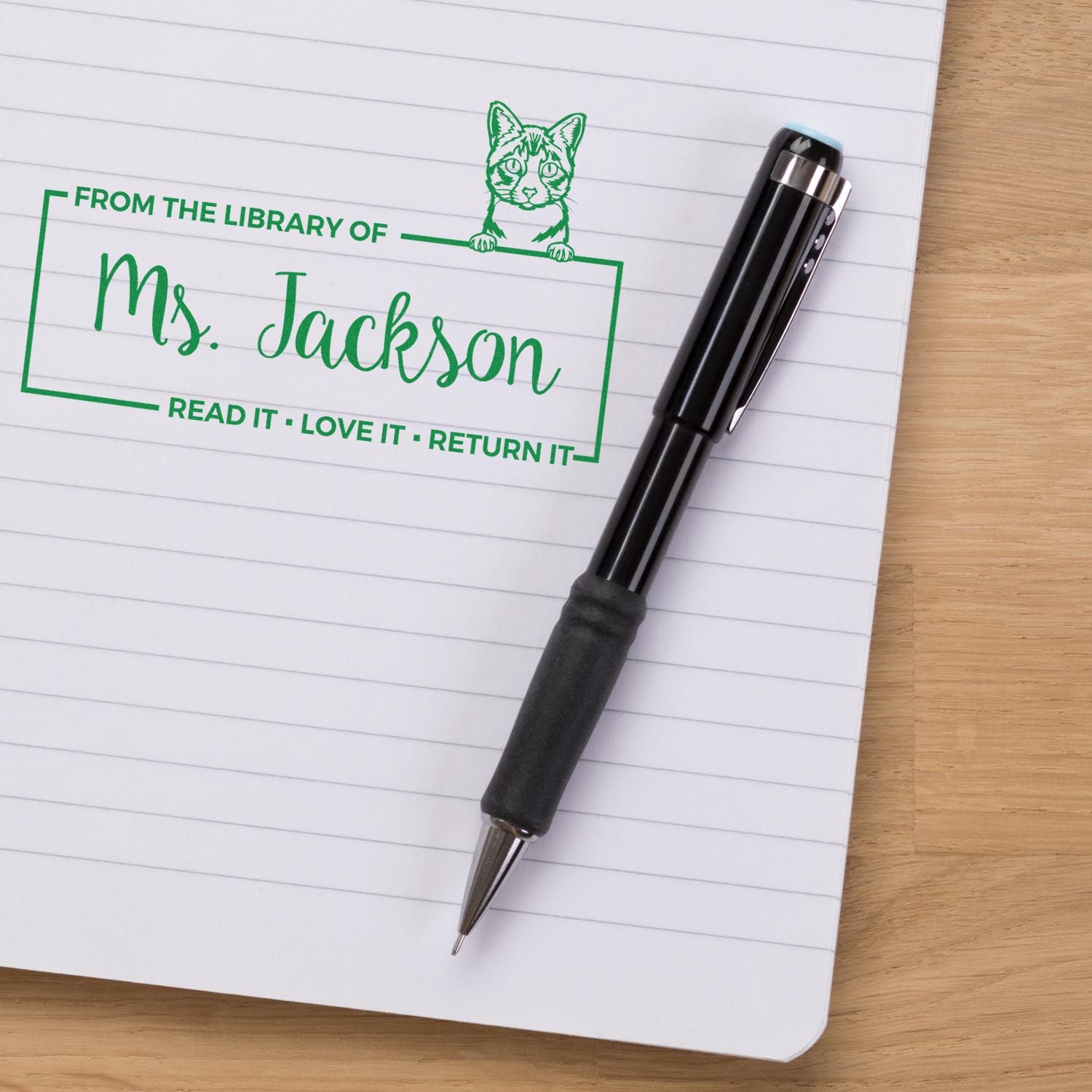 Custom library rubber stamp for Ms. Jackson with cat design and Read it, love it, return it book return message.