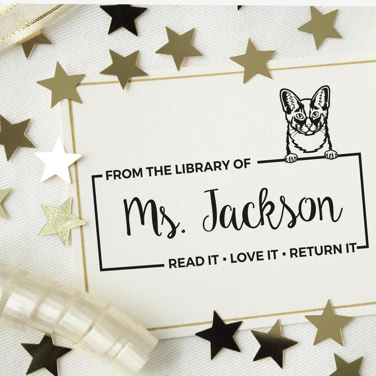 Personalized cat library rubber stamp for Ms. Jackson, with Read It, Love It, Return It bookplate text.