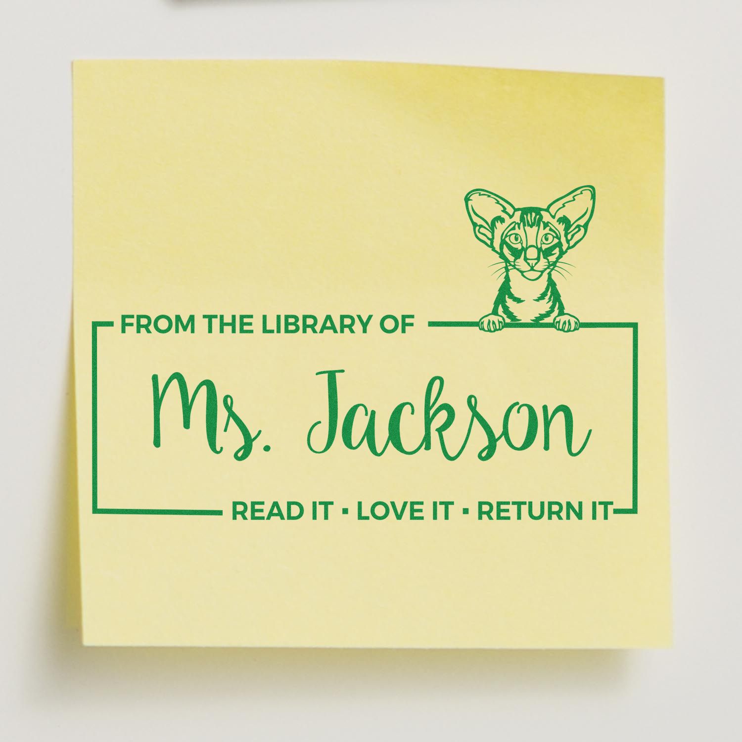 Personalized cat library rubber stamp for Ms. Jackson, featuring bookplate text Read It Love It Return It.