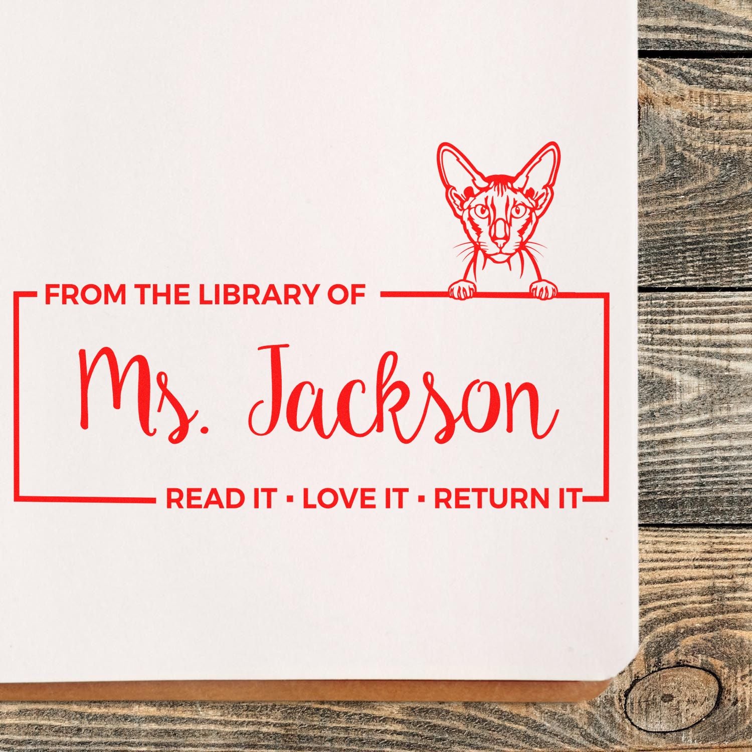 Custom rubber stamp for Ms. Jacksons library books with cat design and Read It, Love It, Return It message.