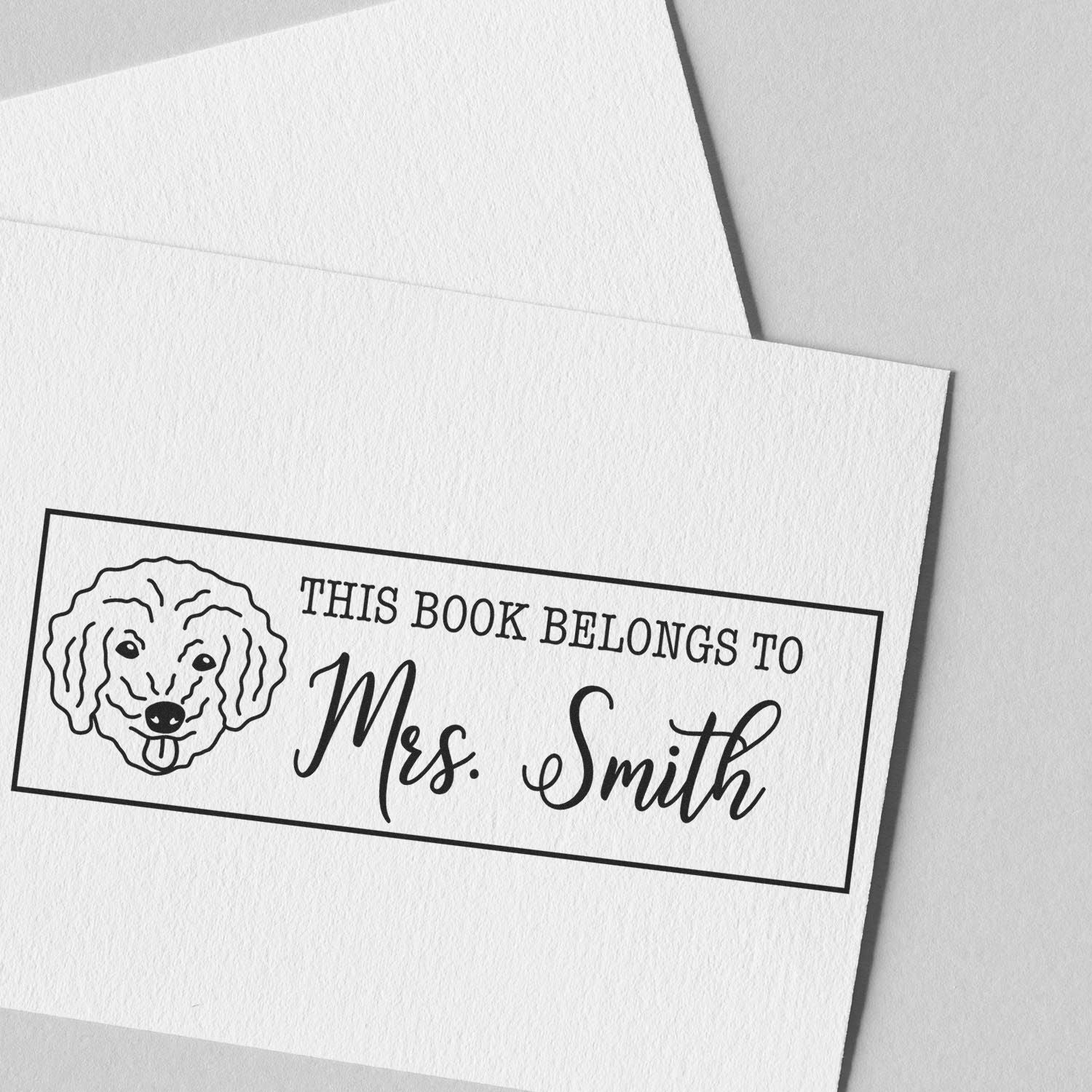 Personalized bookplate rubber stamp with dog illustration and Mrs. Smith name, custom ex libris for library books.