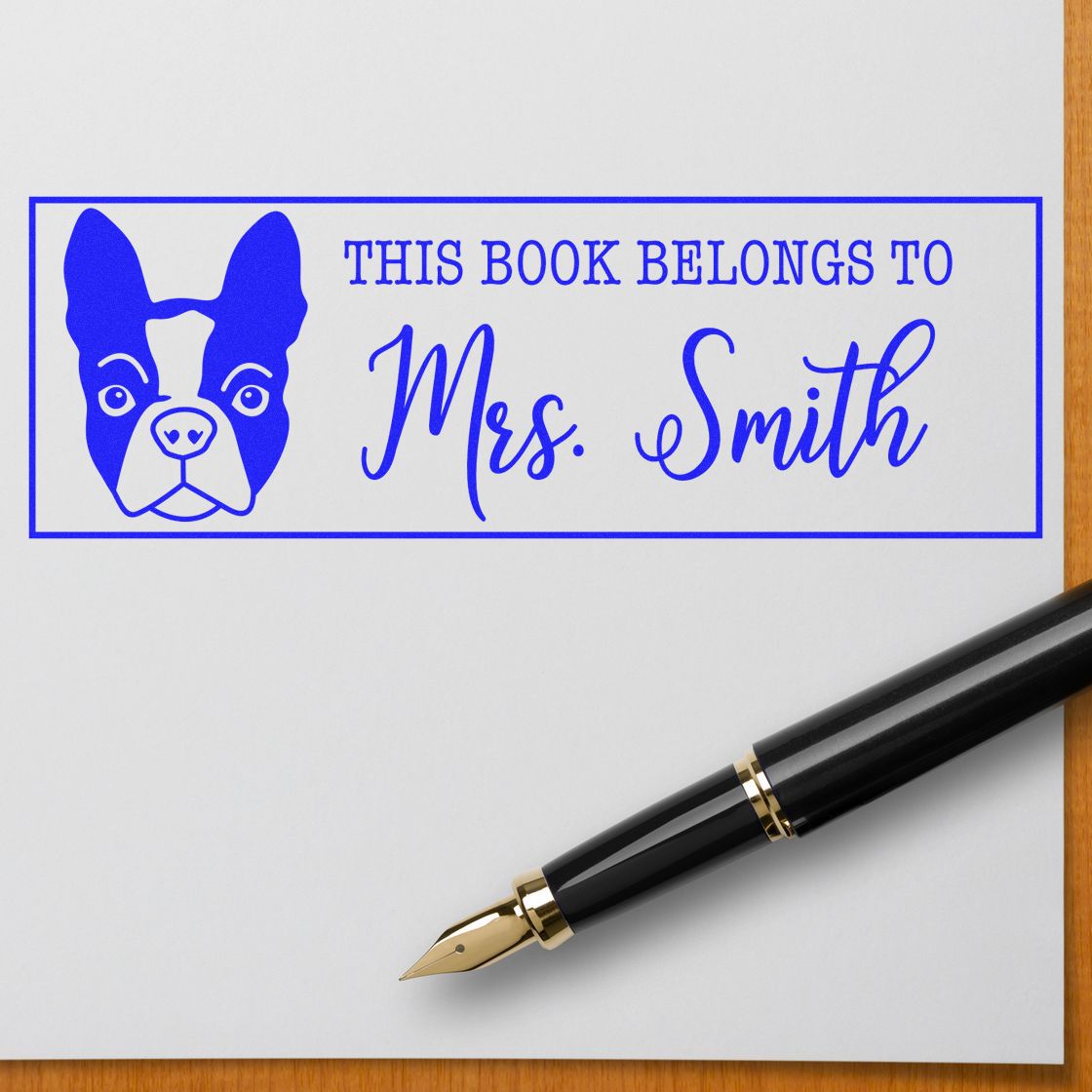 Personalized rubber book stamp with dog design, reading This book belongs to Mrs. Smith for custom library ownership.