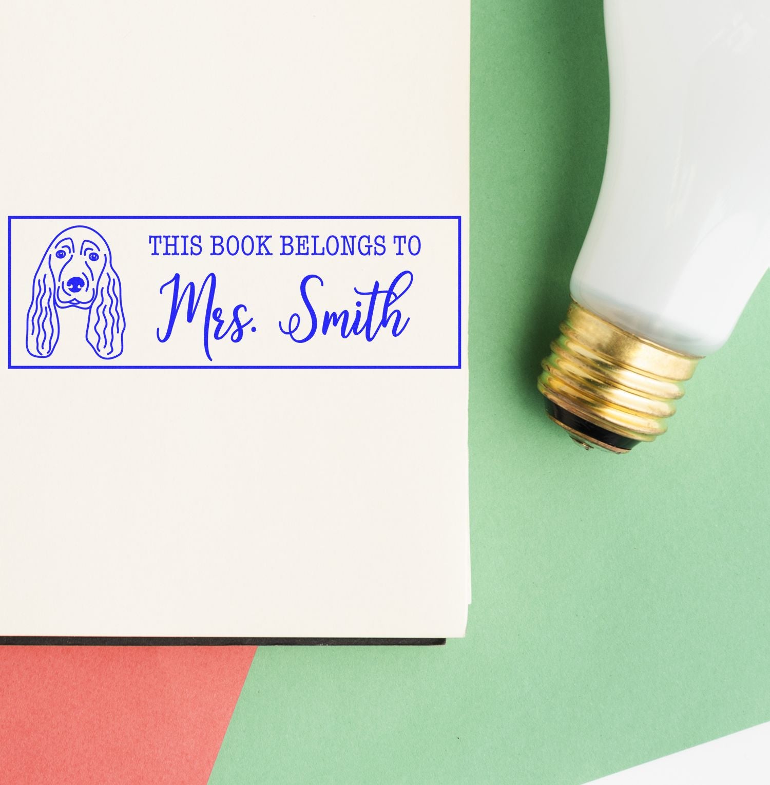 Personalized rubber book stamp with dog design and This Book Belongs To Mrs. Smith for custom library labeling.