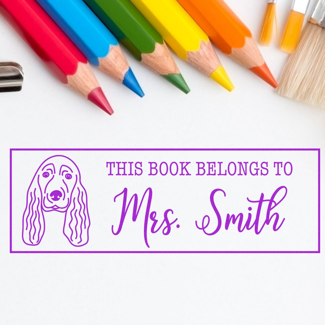 Personalized rubber book stamp with dog illustration and This Book Belongs to Mrs. Smith for classroom or library books.
