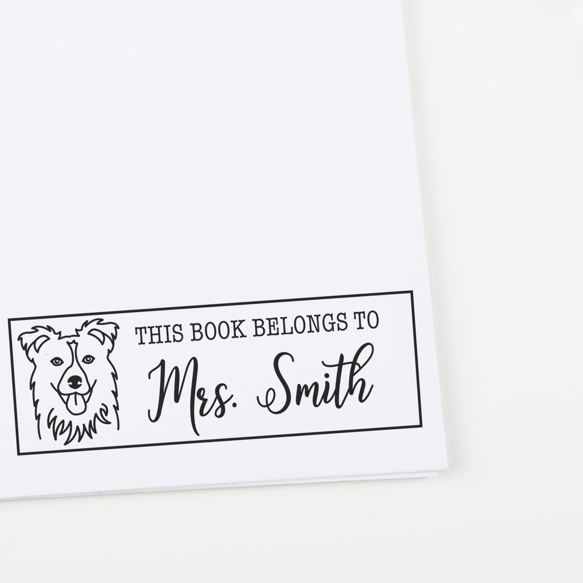 Custom dog rubber stamp for books reading This Book Belongs to Mrs. Smith for personalized library books.