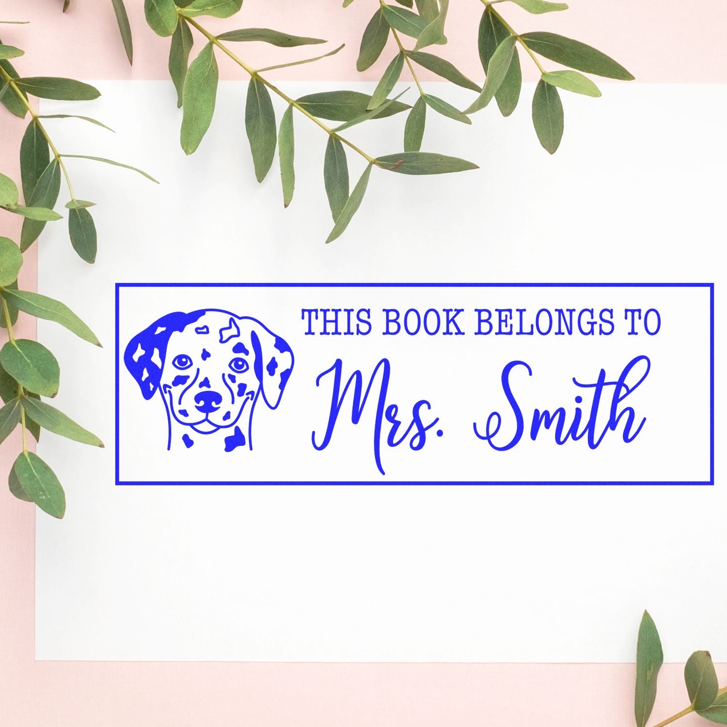 Personalized book rubber stamp with Dalmatian design and This Book Belongs to Mrs. Smith text.