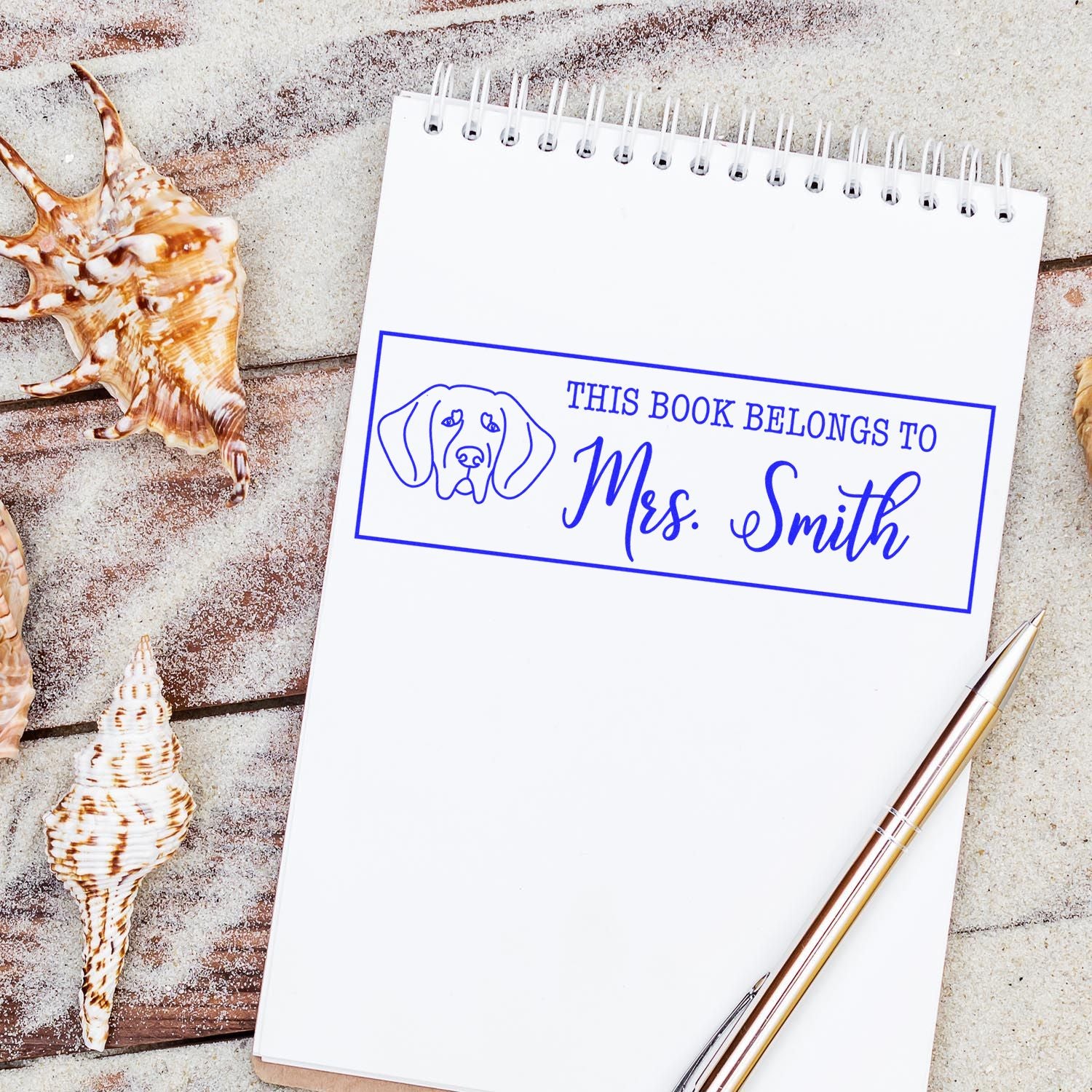 Custom dog book stamp on notebook: This Book Belongs to Mrs. Smith personalized rubber stamp for teachers and readers.
