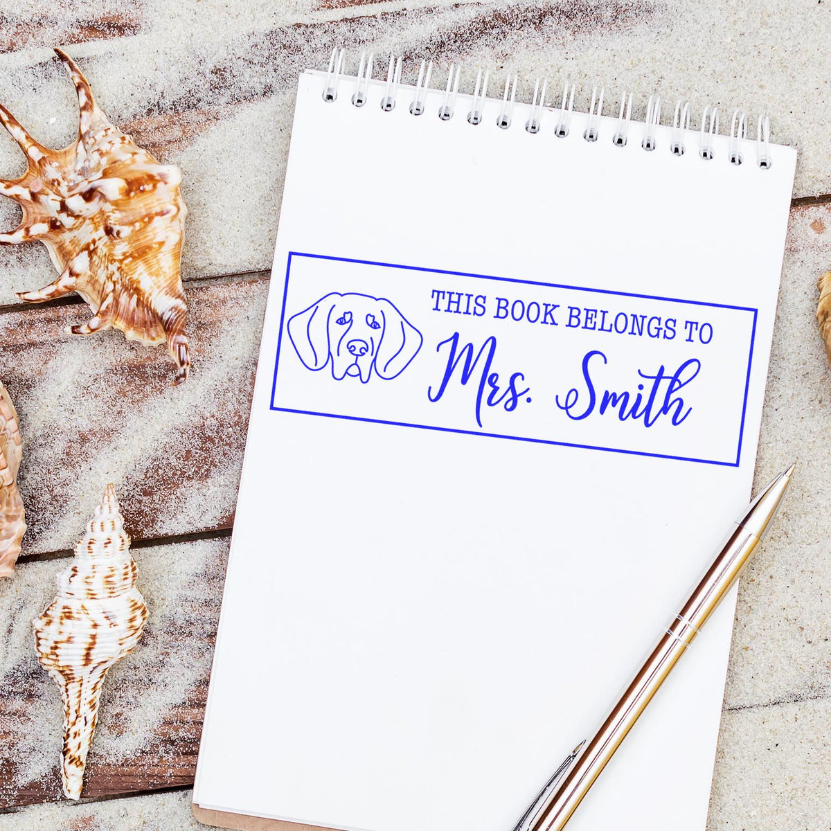 Custom rubber stamp with dog design reading This Book Belongs to Mrs. Smith for personalizing books and journals.