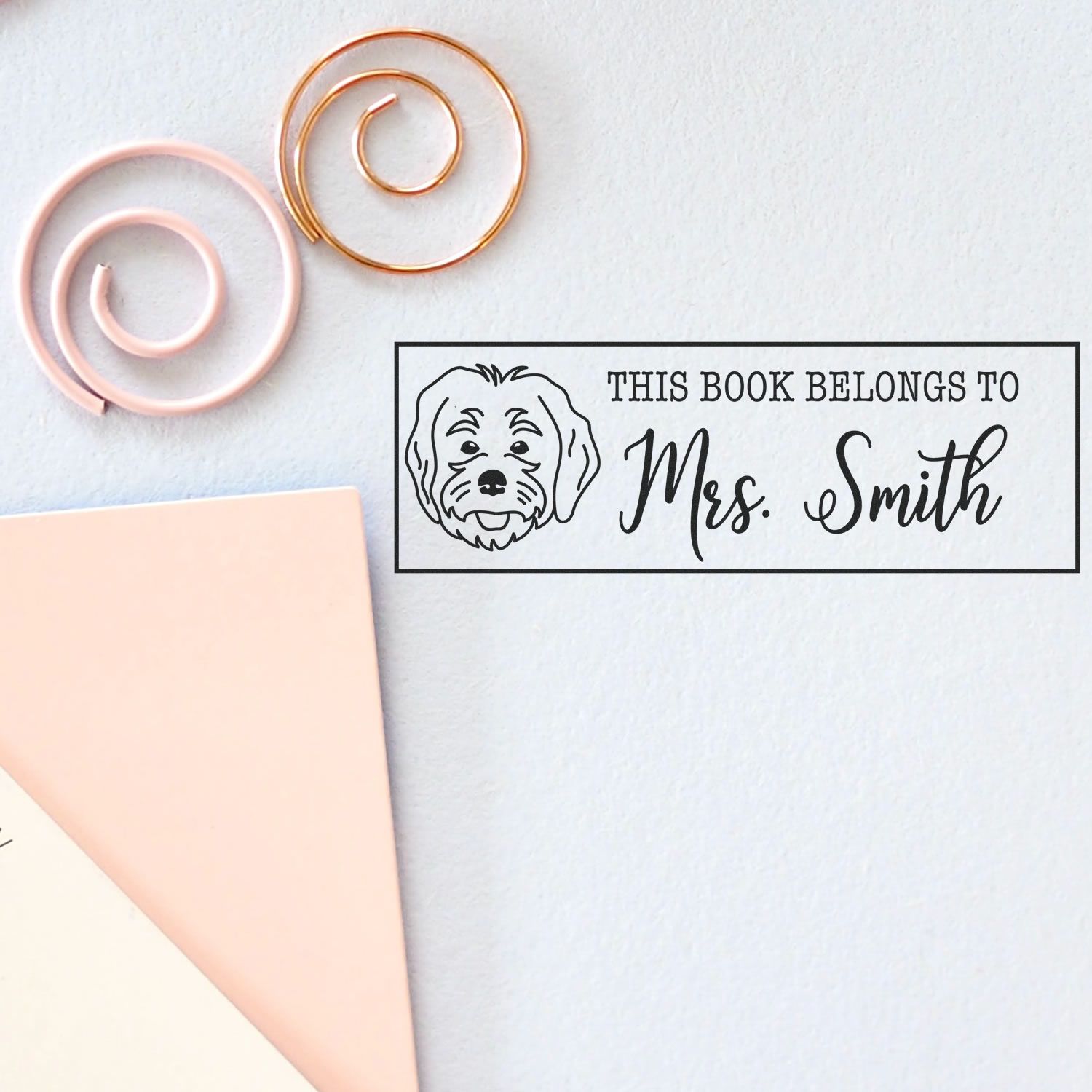 Personalized rubber book stamp with dog illustration and This Book Belongs to Mrs. Smith for library books and teachers.