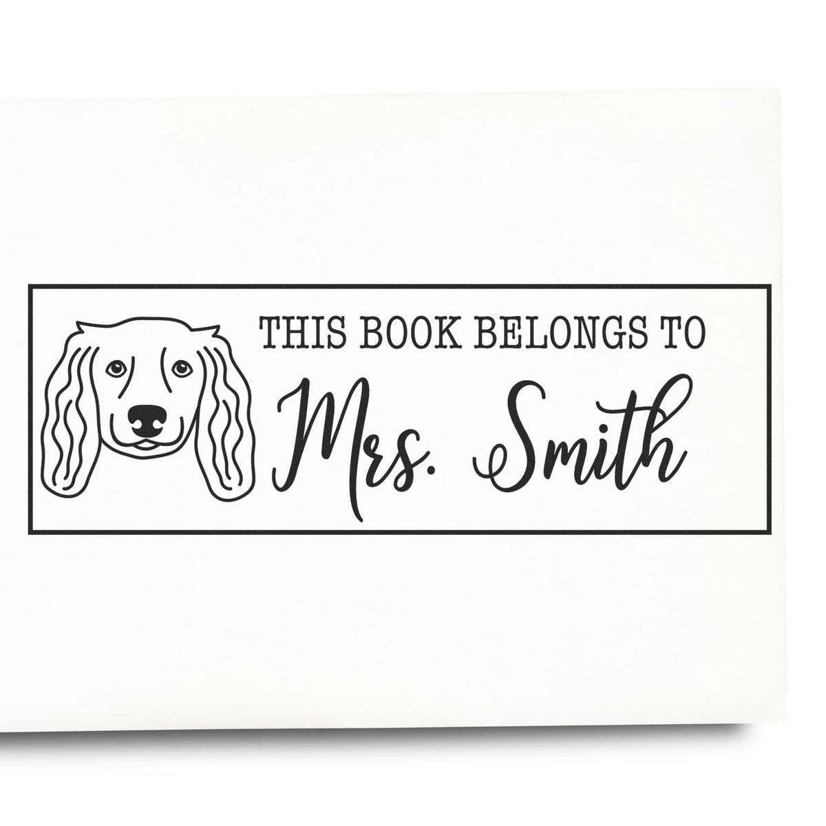 Personalized dog-themed rubber stamp reading This Book Belongs To Mrs. Smith for labeling books.
