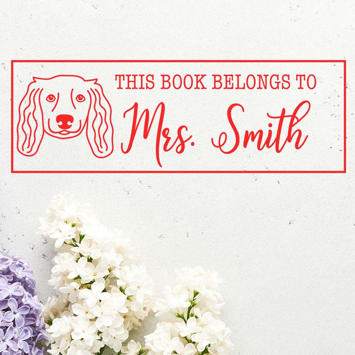 Personalized dog-themed rubber stamp reading This Book Belongs to Mrs. Smith for custom book ownership labels.