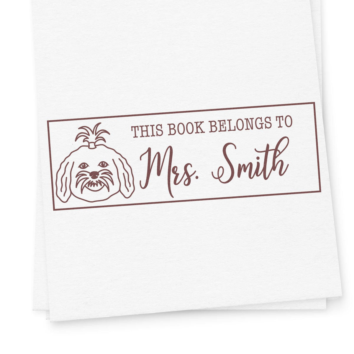 Personalized book rubber stamp with dog illustration and This Book Belongs to Mrs. Smith text for custom library labels.
