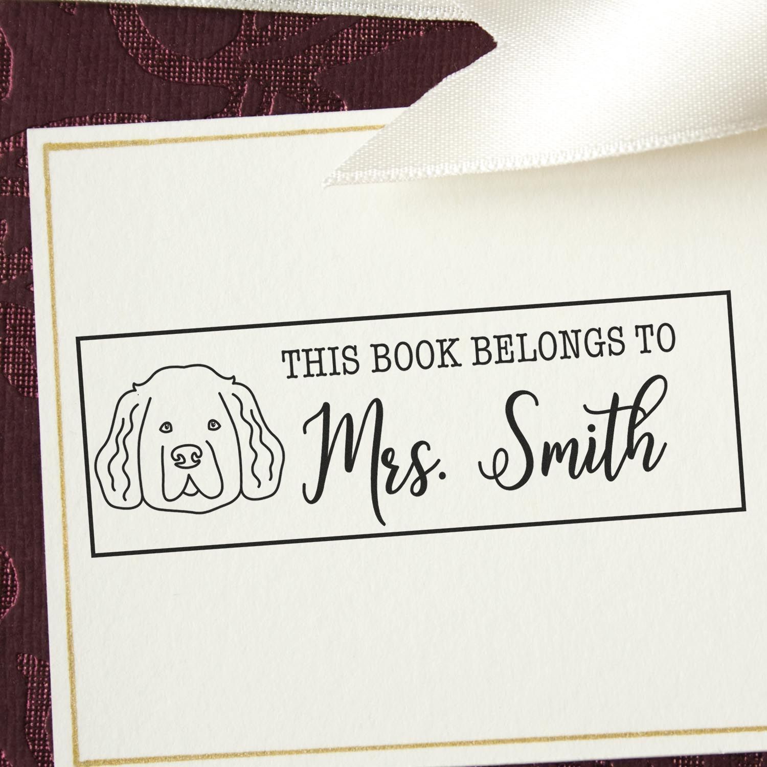 Personalized rubber stamp for books with dog illustration, reading This Book Belongs to Mrs. Smith for home library or classroom.