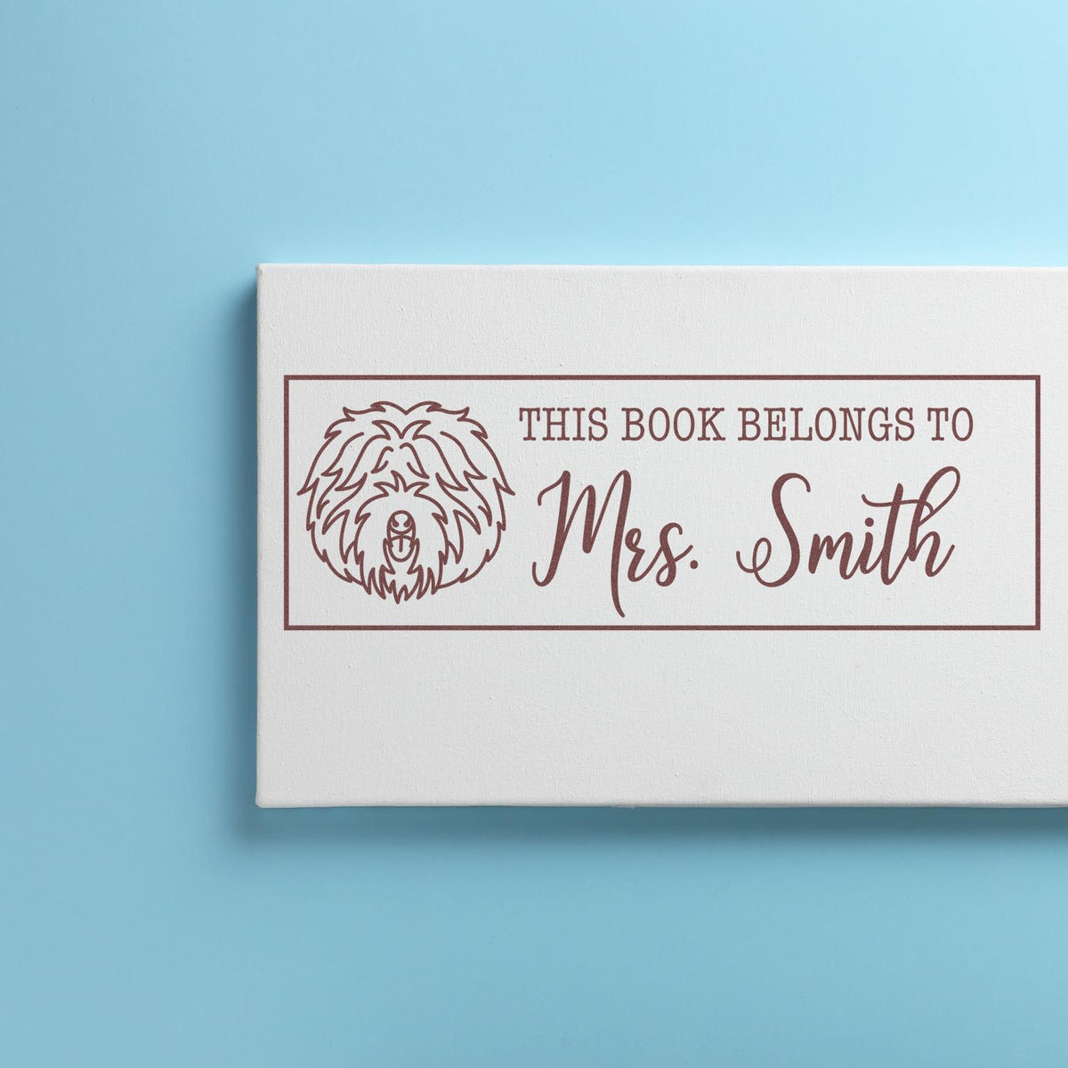 Personalized rubber stamp for books with dog design and This book belongs to Mrs. Smith text.