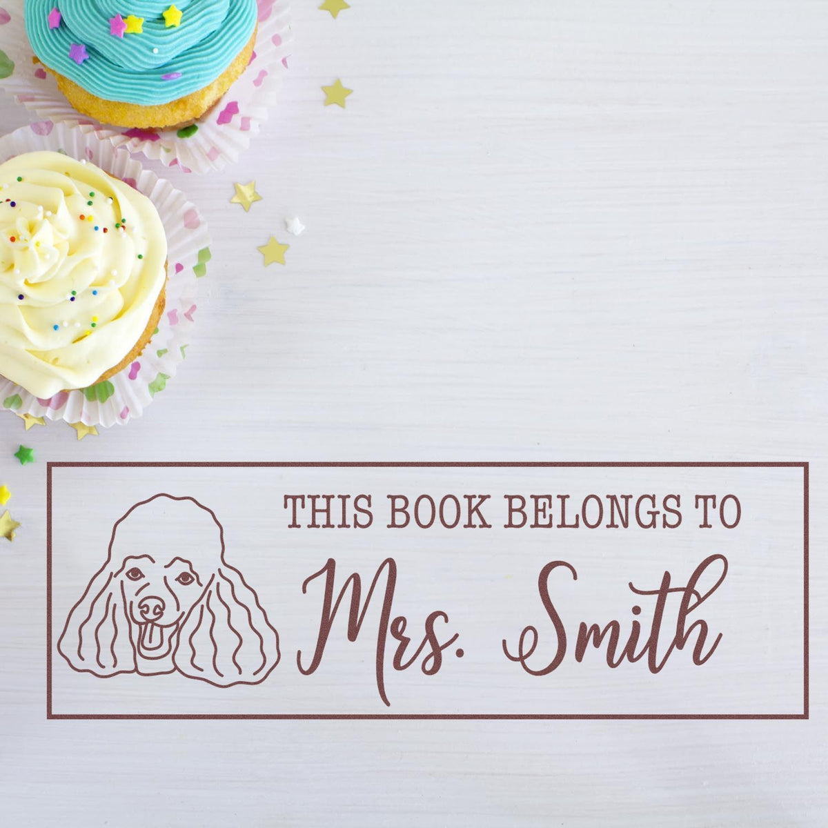 Personalized rubber book stamp with dog illustration and This Book Belongs to Mrs. Smith for custom library labeling.