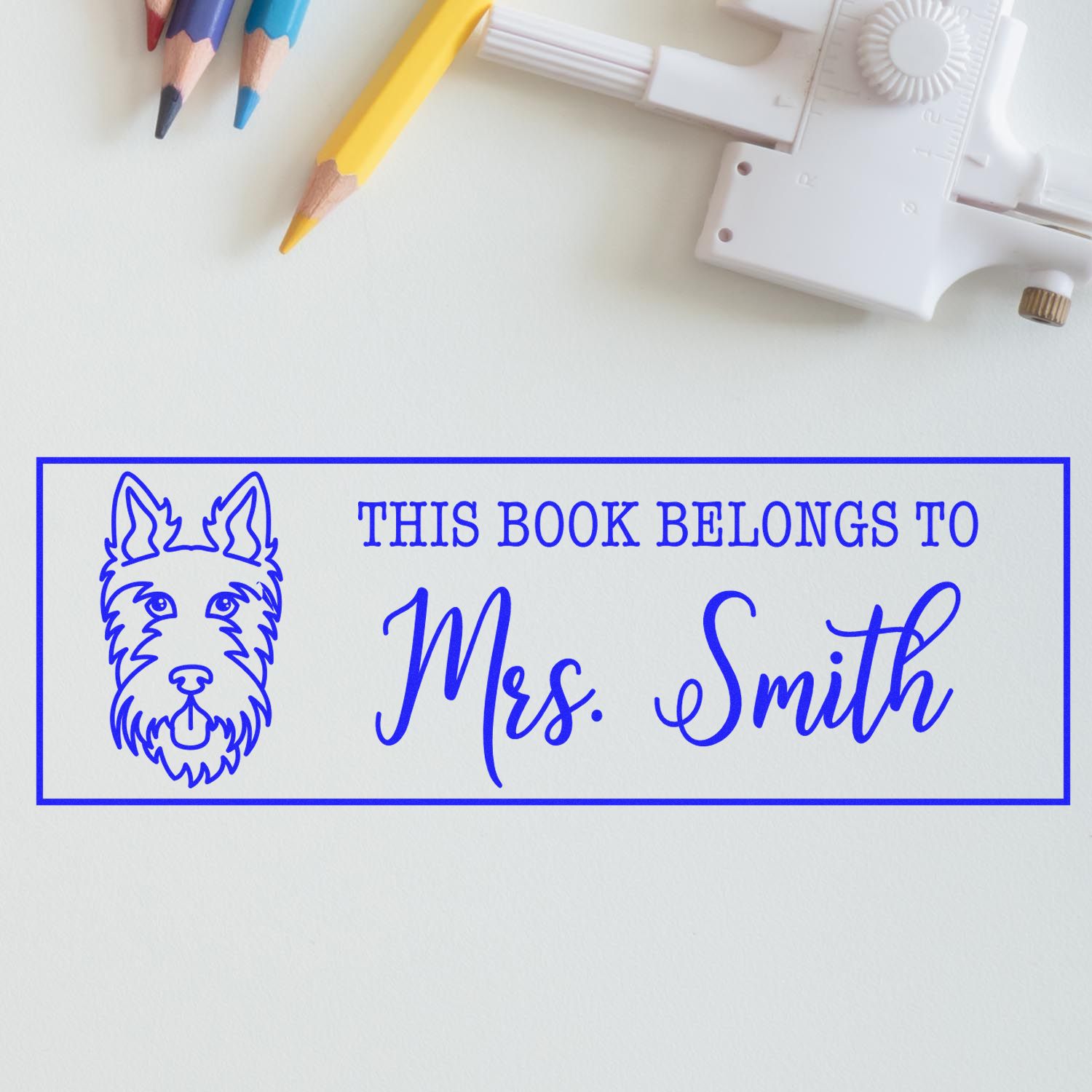 Custom book belongs to rubber stamp with dog design and Mrs. Smith name for personalized library books and home collection.
