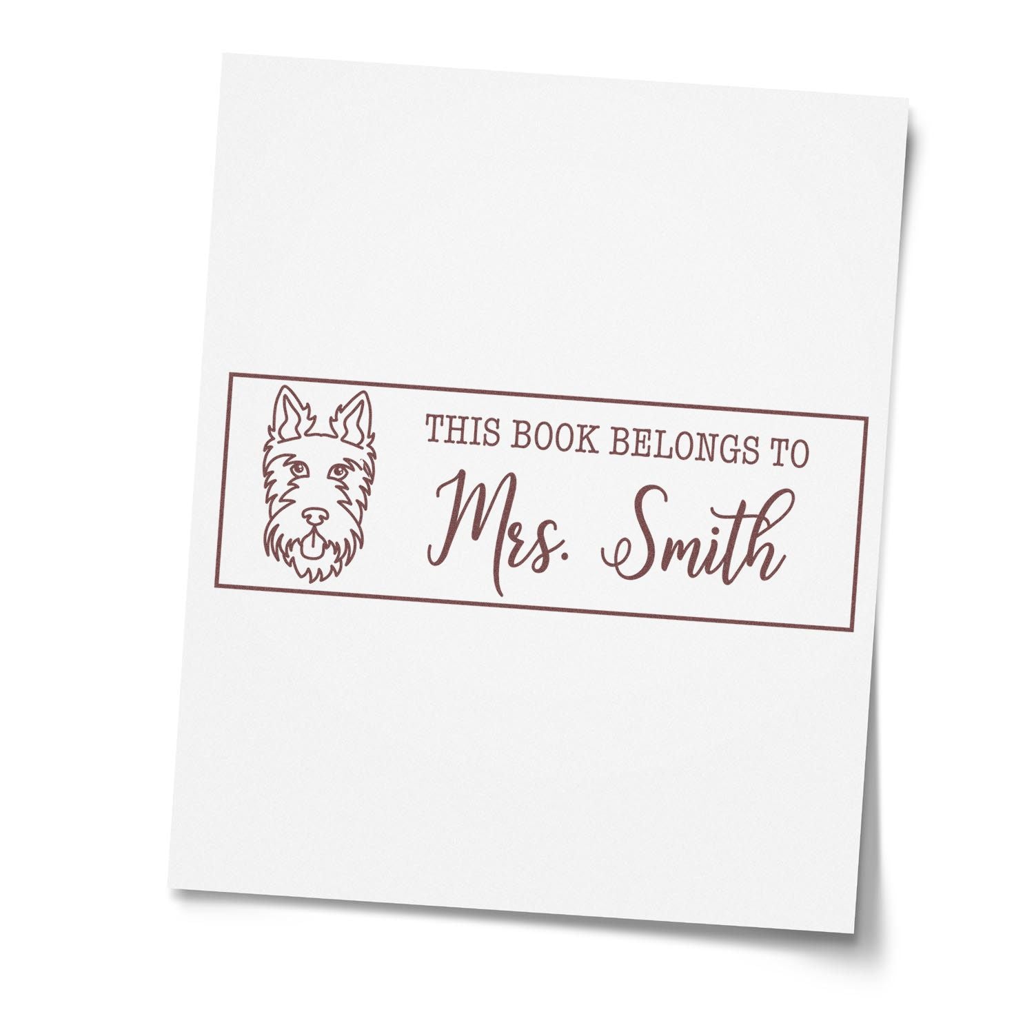 Custom rubber book stamp with dog design, reading This Book Belongs to Mrs. Smith for personalized library ownership.