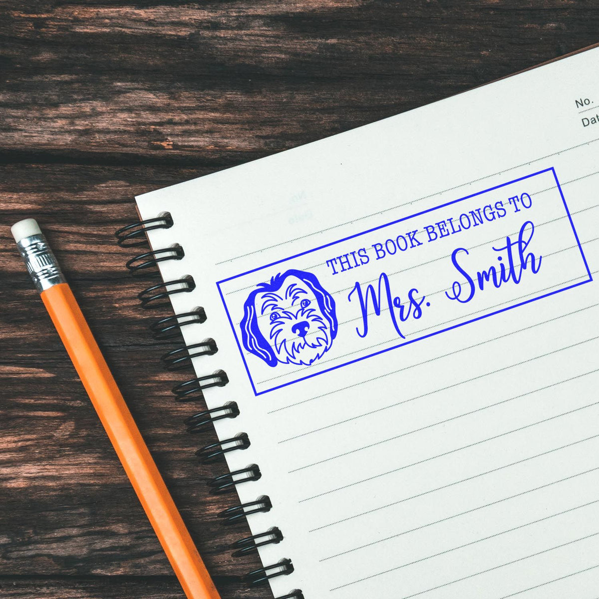 Custom rubber book stamp with dog illustration, featuring This Book Belongs to Mrs. Smith for personal library labeling.