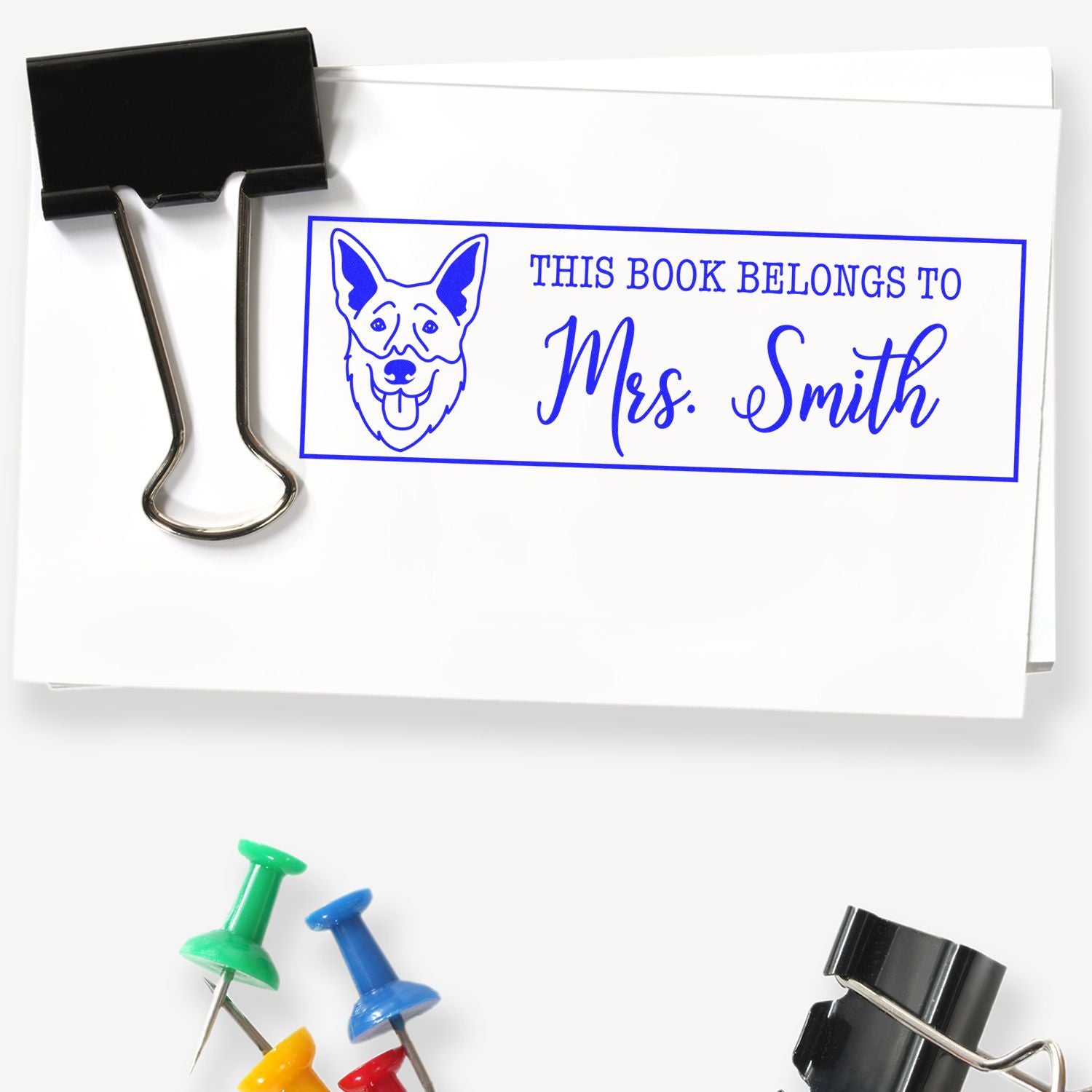 Personalized rubber book stamp with dog design and This Book Belongs to Mrs. Smith for labeling classroom or home library books.