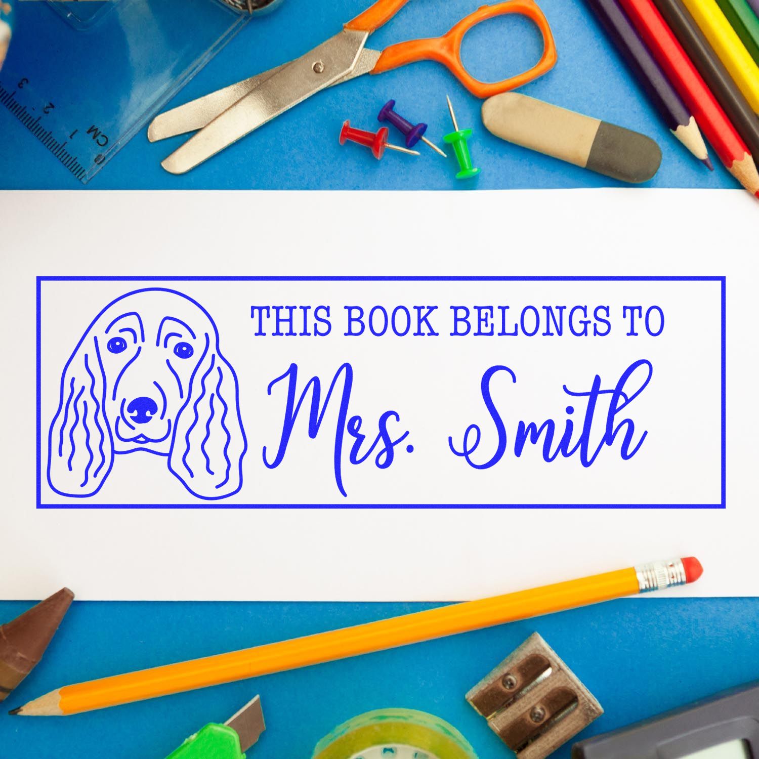 Custom rubber book stamp with dog design and This Book Belongs to Mrs. Smith for classroom library books.