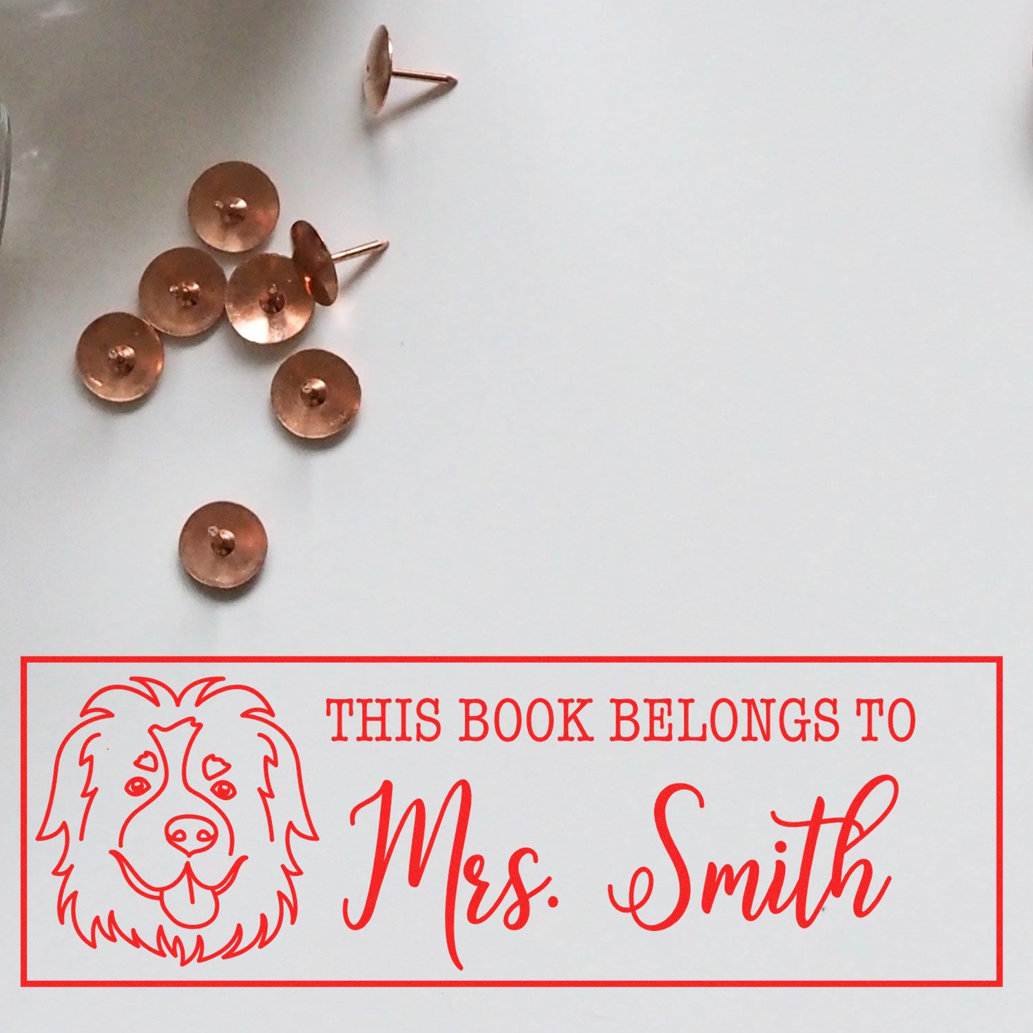 Custom rubber stamp for books with dog illustration and This Book Belongs to Mrs. Smith personalized ex libris design.
