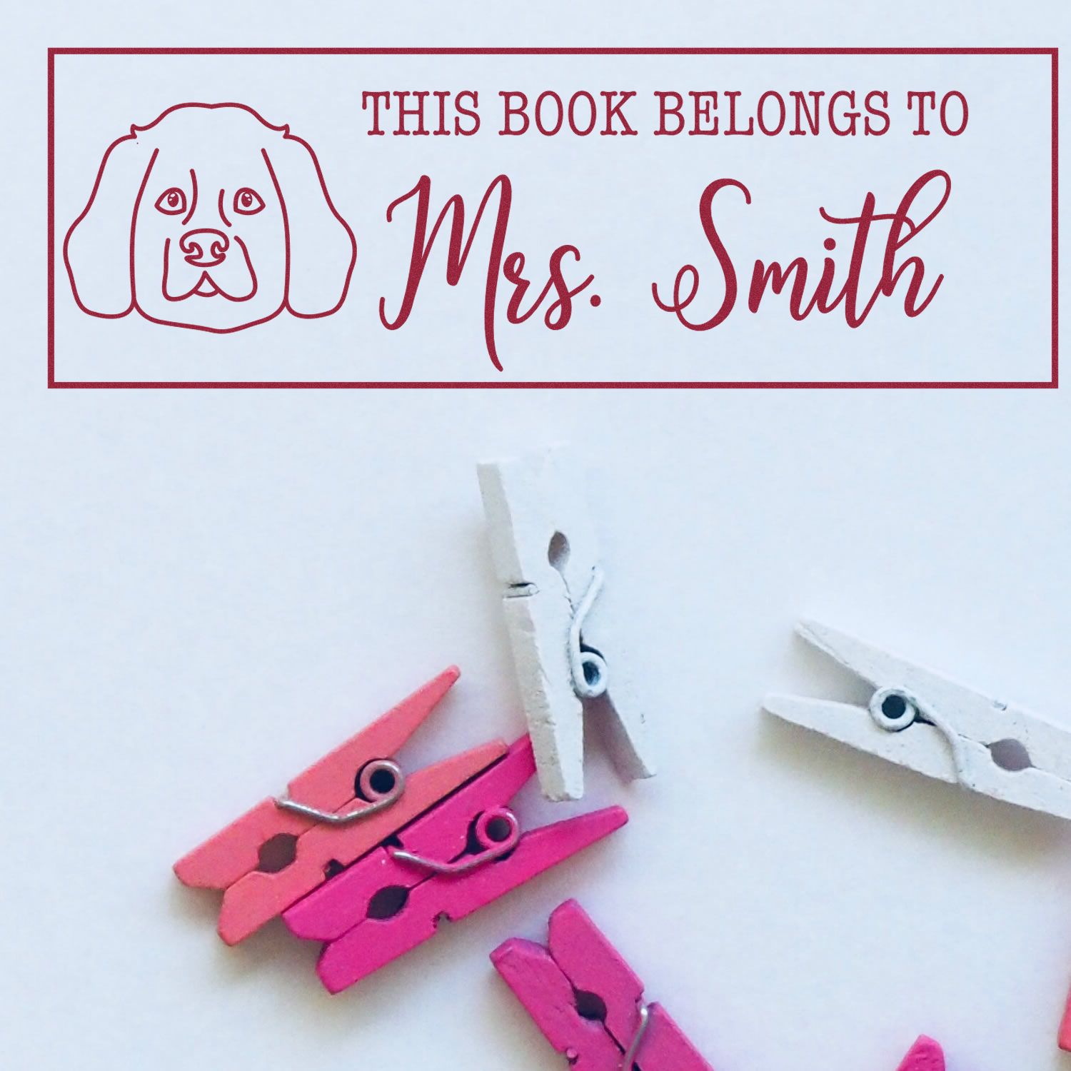 Personalized rubber stamp reading This Book Belongs to Mrs. Smith with dog icon for book labeling and library use.
