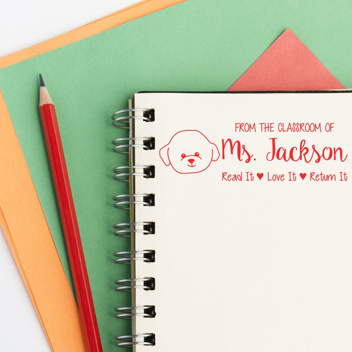 Personalized teacher rubber stamp on notebook: From the Classroom of Mrs. Jackson, Read It Love It Return It book label.