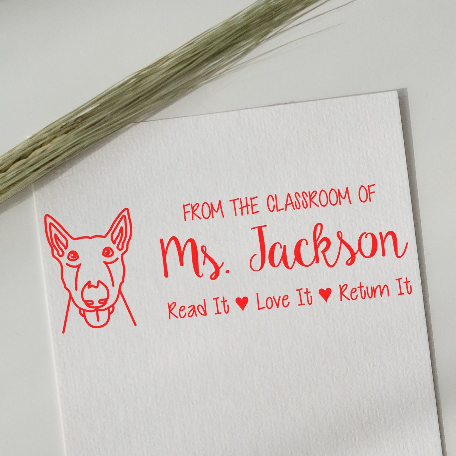 Custom teacher rubber stamp for Ms. Jackson with dog icon and Read It, Love It, Return It classroom book label.