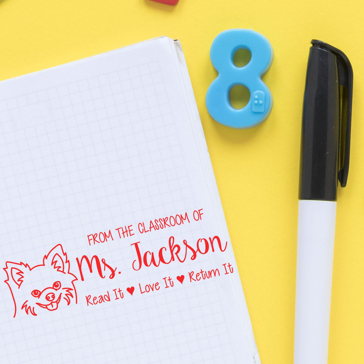 Teacher rubber stamp on notebook: From the Classroom of Ms. Jackson with Read It, Love It, Return It message.