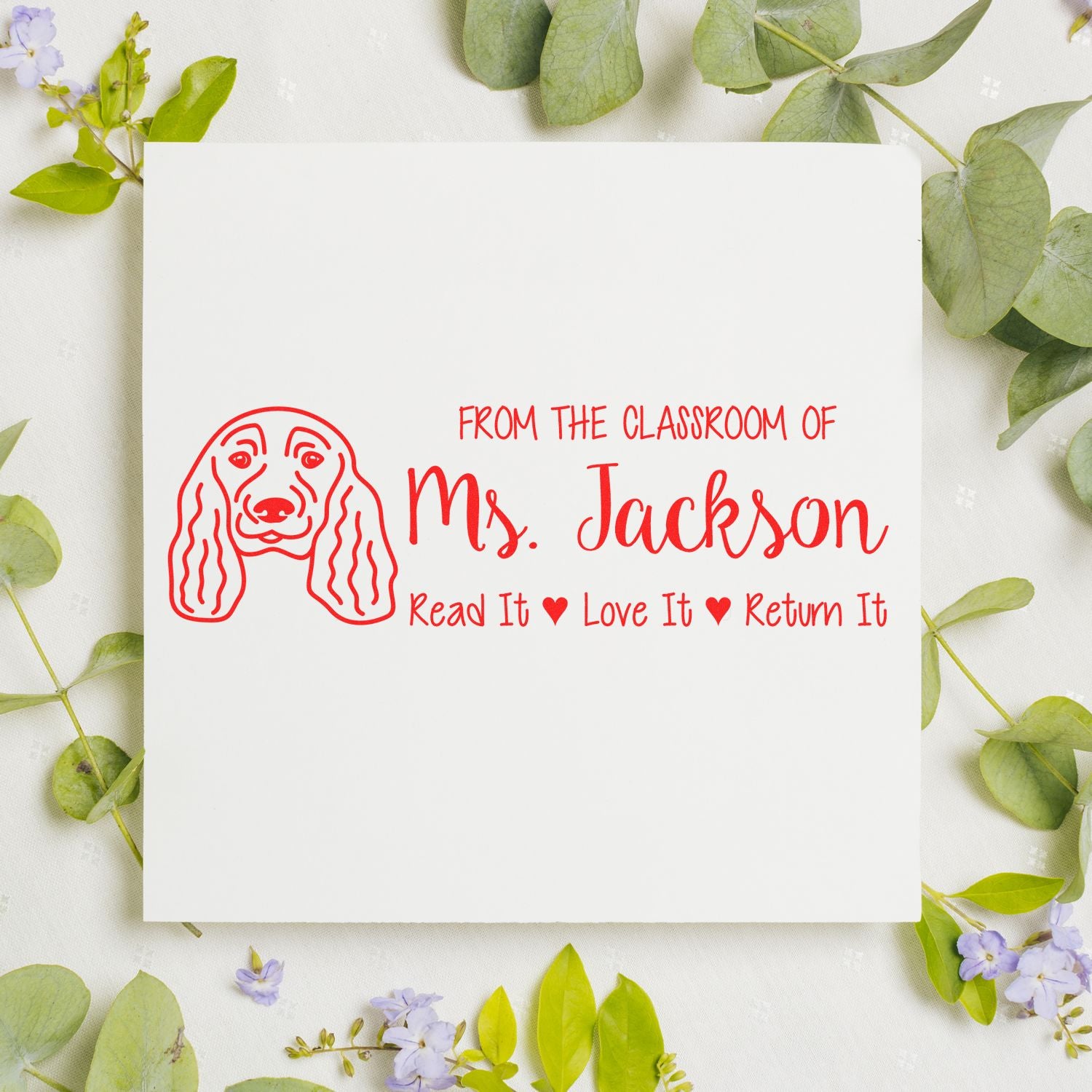 Personalized teacher rubber stamp with dog illustration and Read It Love It Return It book label for Ms. Jackson classroom.