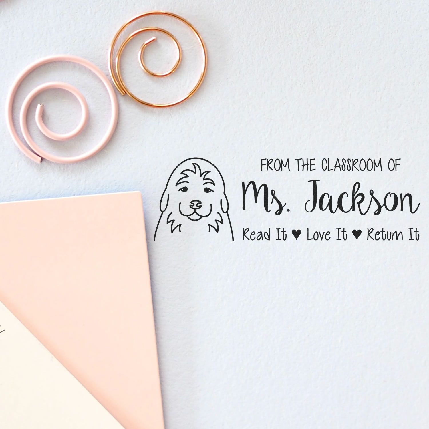 Custom classroom rubber stamp with dog design and Read It Love It Return It text for Ms. Jacksons books.