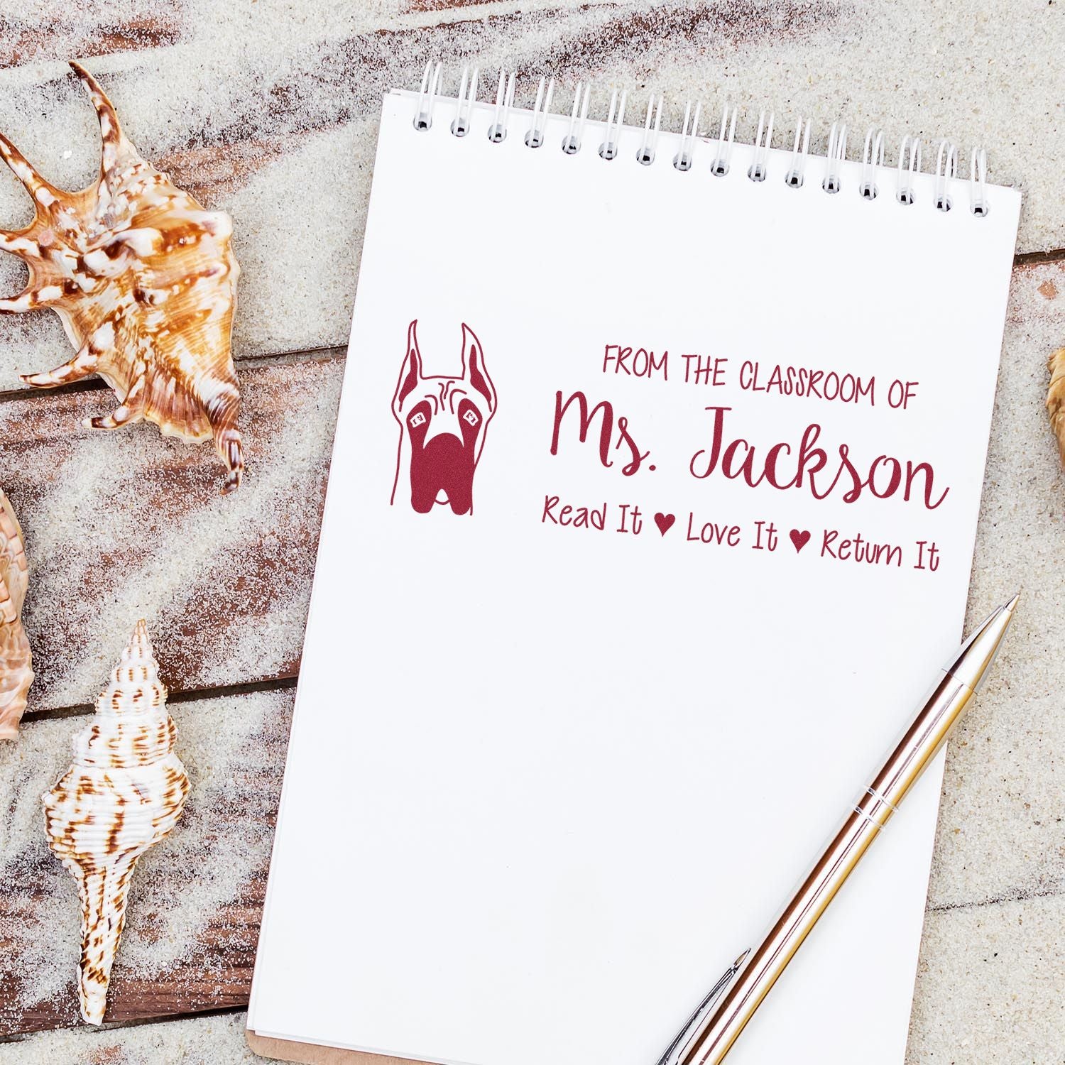 Personalized teacher library rubber stamp design on notebook with dog graphic and Read It, Love It, Return It message.