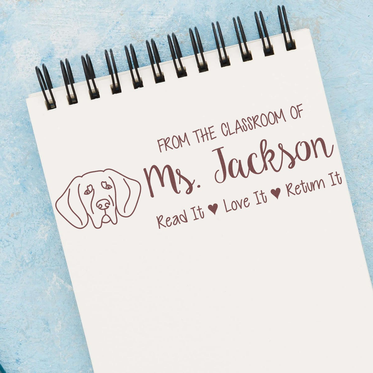 Custom teacher rubber stamp with dog icon and From the Classroom of Ms. Jackson read-it, love-it, return-it book message.