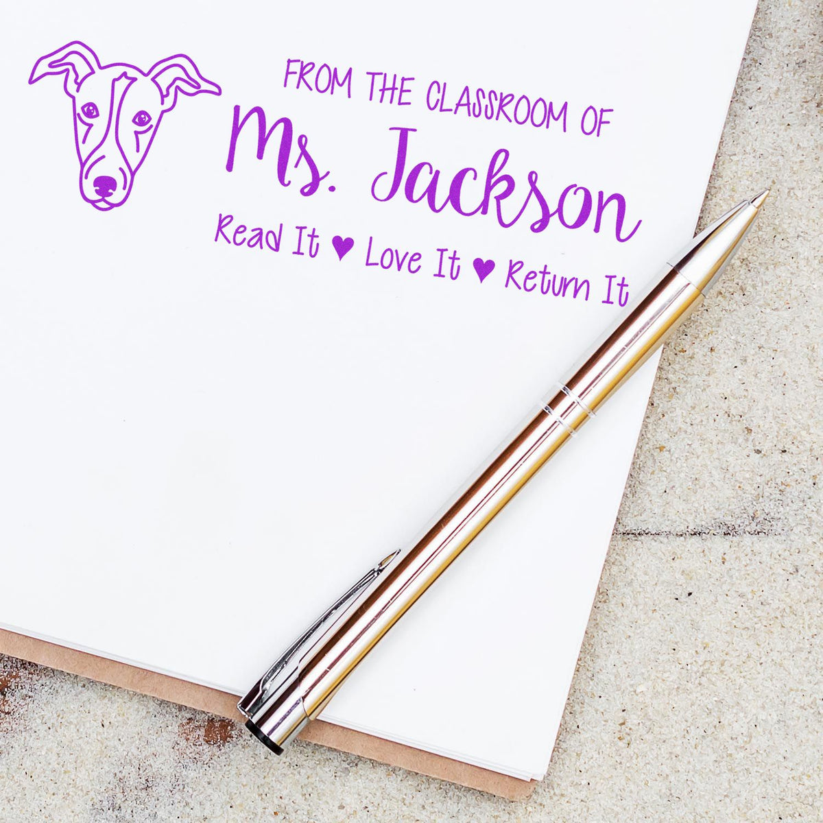 Personalized teacher rubber stamp design with dog logo and Read It, Love It, Return It classroom message for Mrs. Jackson.
