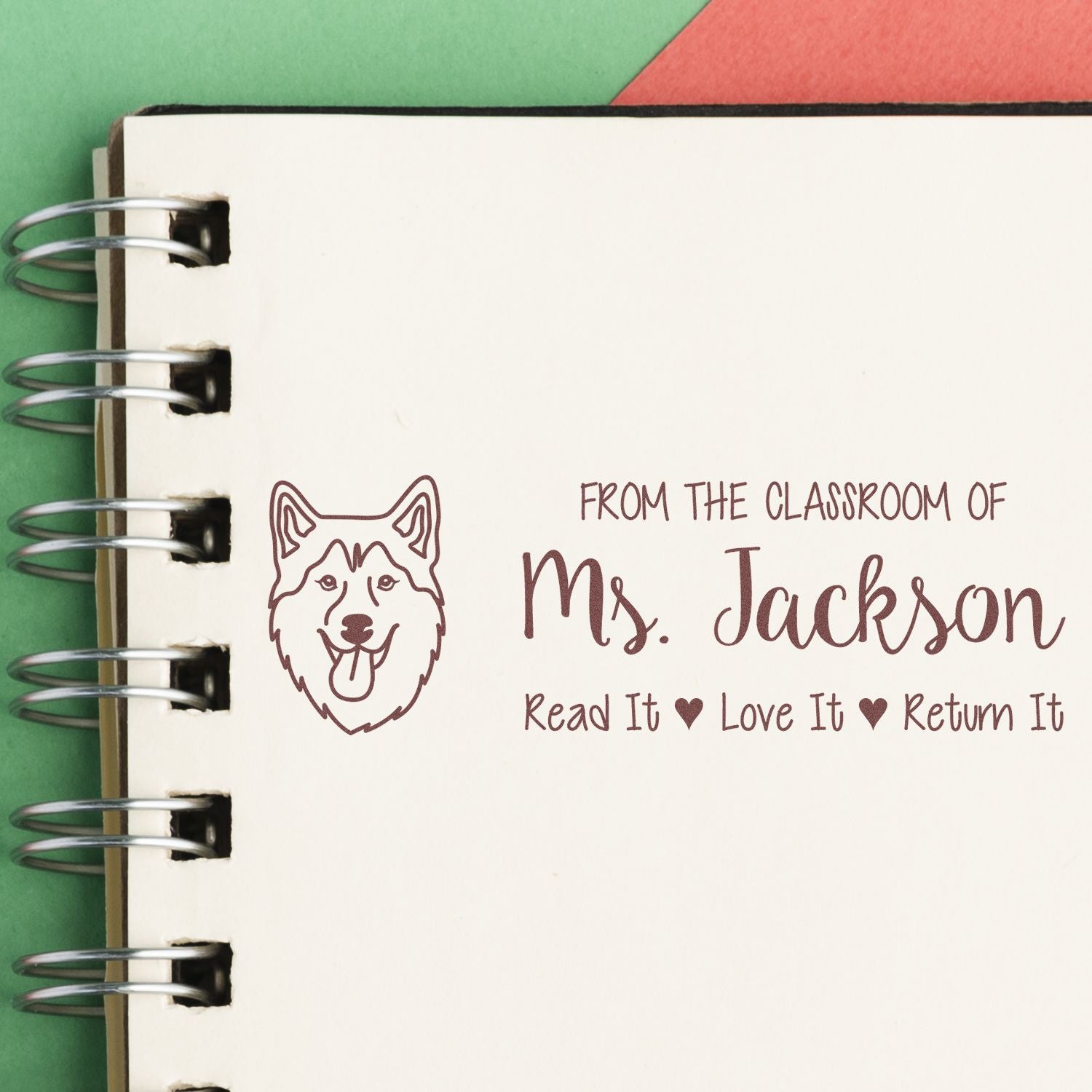 Custom classroom library rubber stamp with dog icon, Ms. Jackson name, and Read It, Love It, Return It book label.