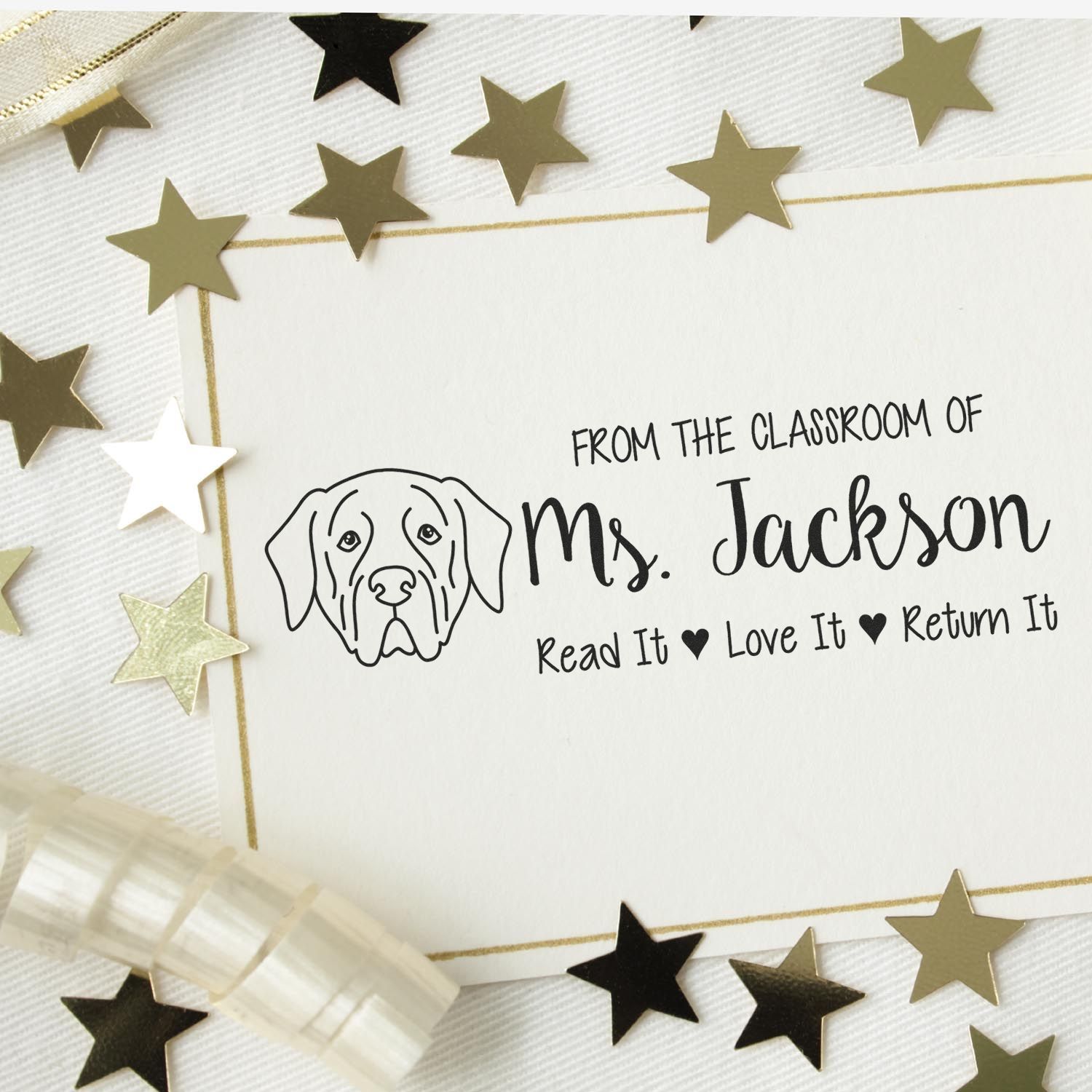Personalized teacher rubber stamp with dog illustration, Ms. Jackson name, and Read It Love It Return It book label.