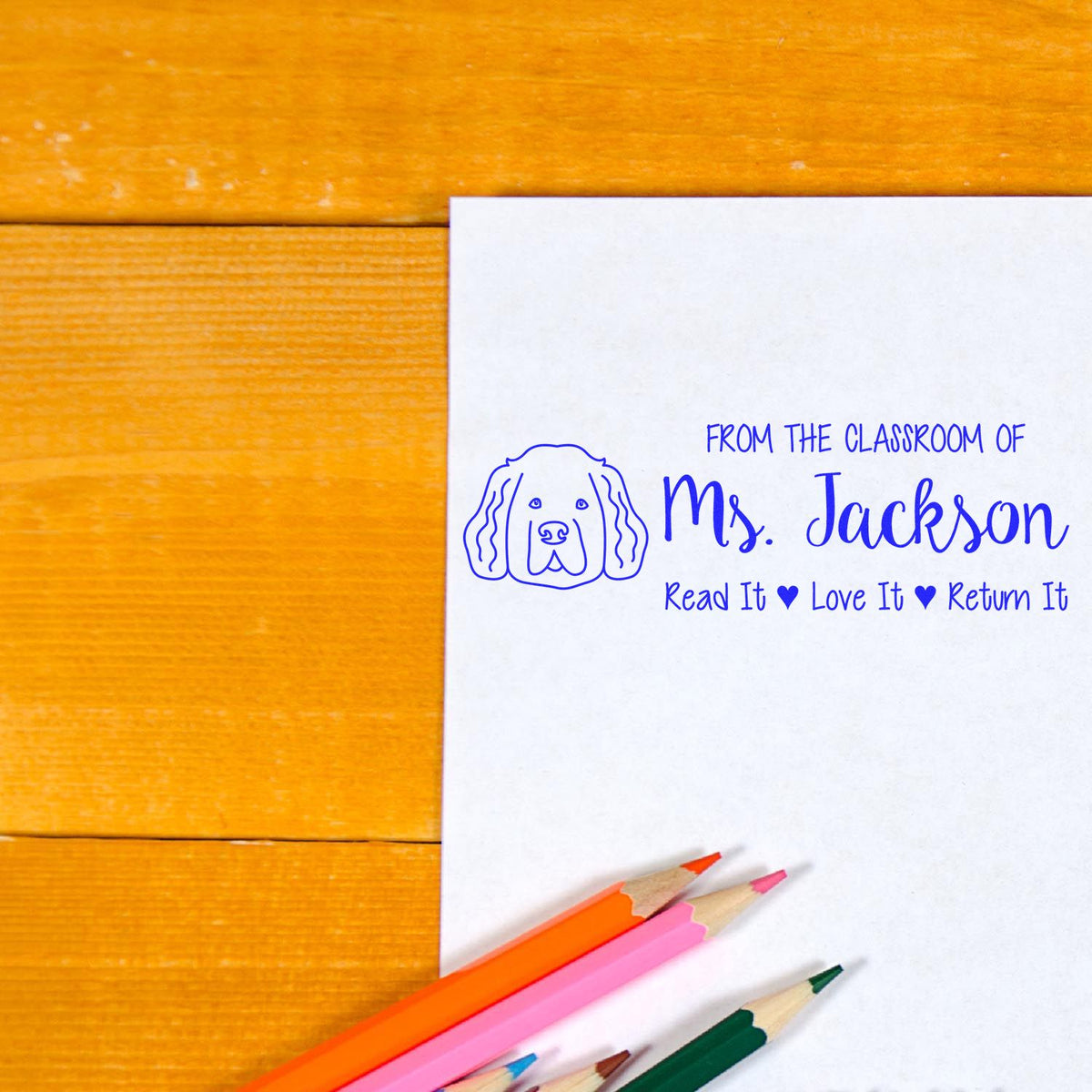 Personalized teacher rubber stamp for Mrs. Jackson with dog icon and Read It, Love It, Return It classroom book label