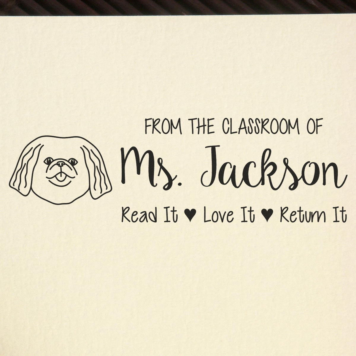 Personalized teacher rubber stamp for classroom books, reading From the Classroom of Ms. Jackson and Read It Love It Return It.