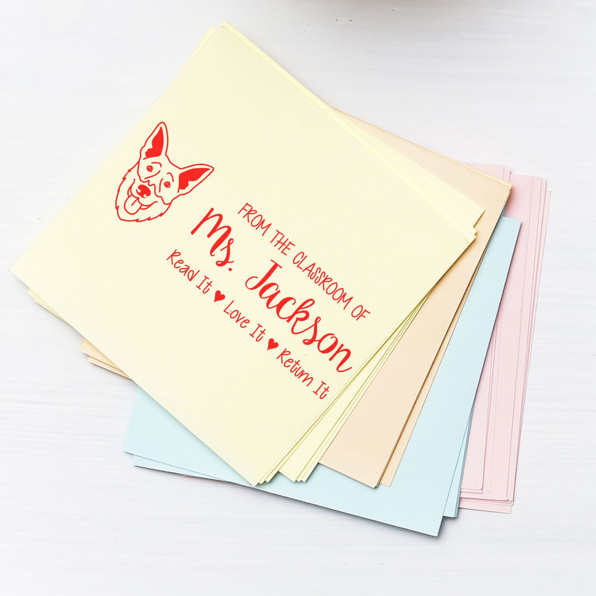 Custom classroom rubber stamp imprint reading From the classroom of Ms. Jackson on pastel paper sheets with dog graphic.