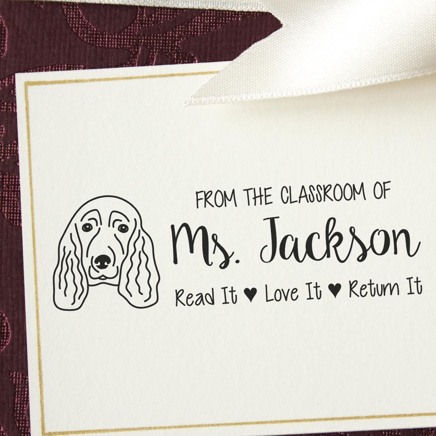 Custom teacher rubber stamp with dog illustration and From the Classroom of Ms. Jackson Read It, Love It, Return It message.
