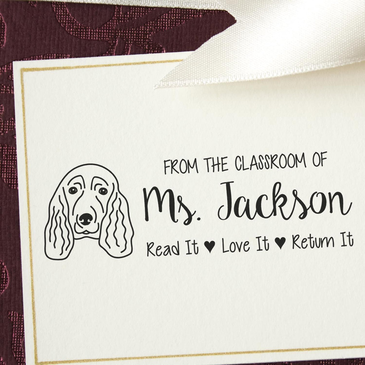Personalized teacher rubber stamp with dog design, From the Classroom of Ms. Jackson and Read It, Love It, Return It text.