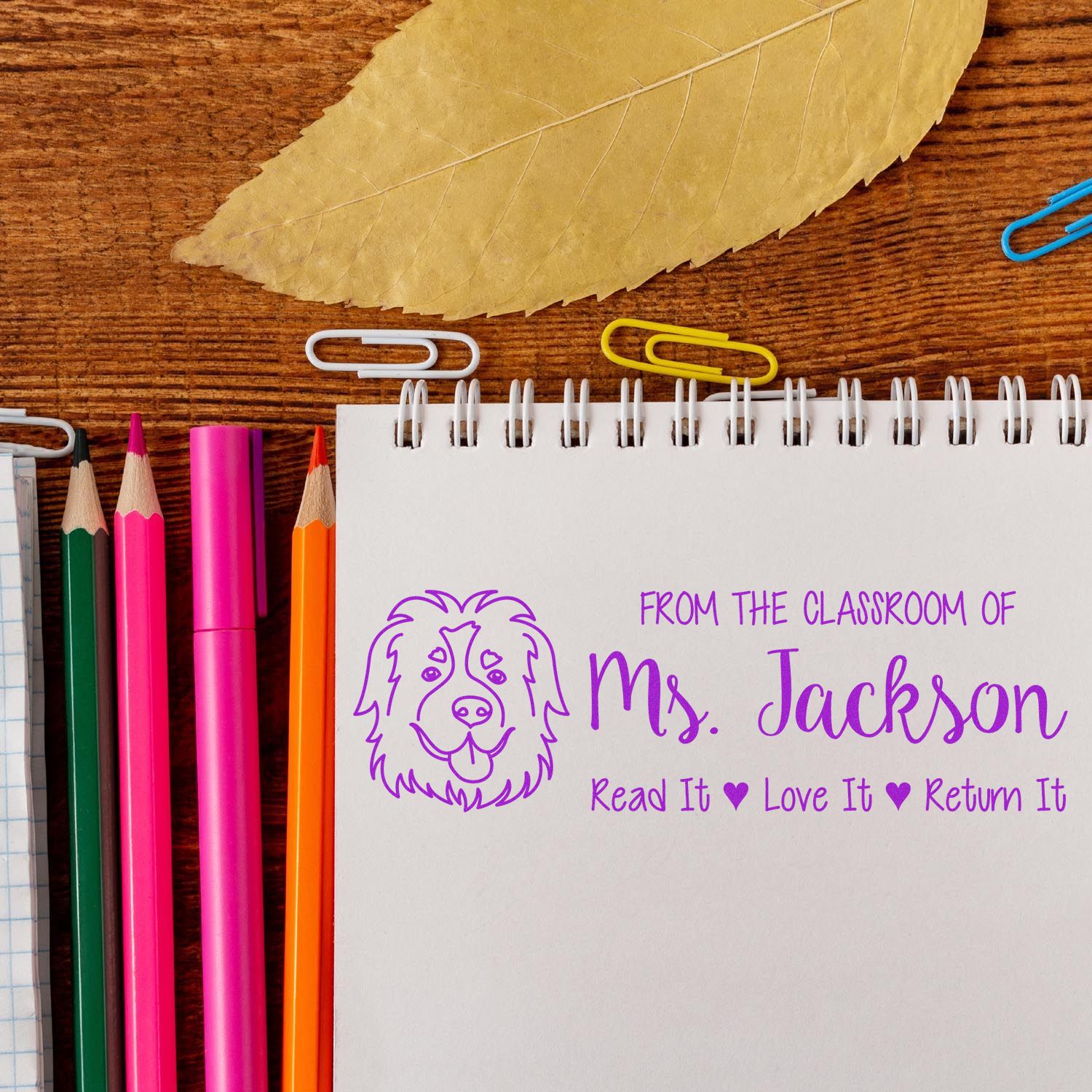 Personalized classroom rubber stamp for Ms. Jackson with dog logo and Read It, Love It, Return It message.